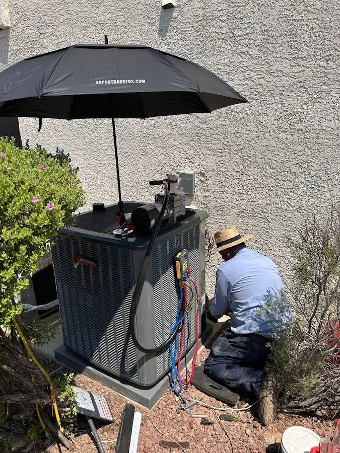 HVAC technician performing outdoor AC maintenance in Richfield
