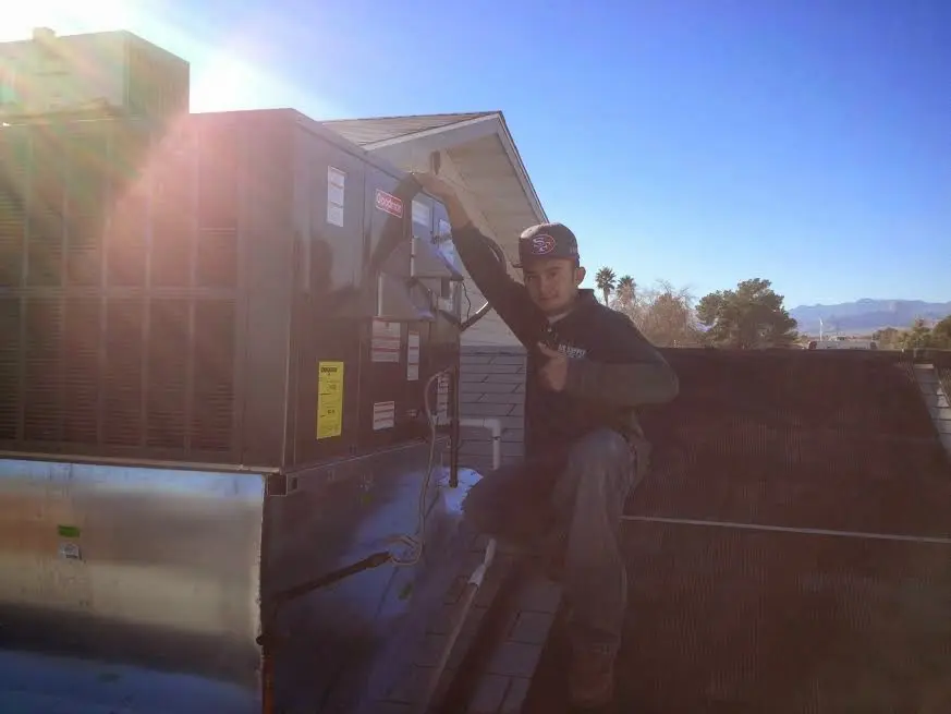 HVAC technician performing Boiler Repair on a rooftop unit in Richfield